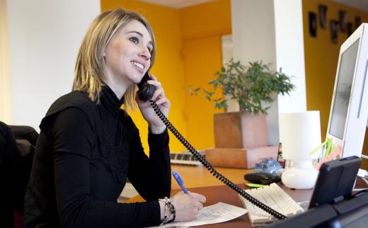 A receptionist fields incoming phone calls.