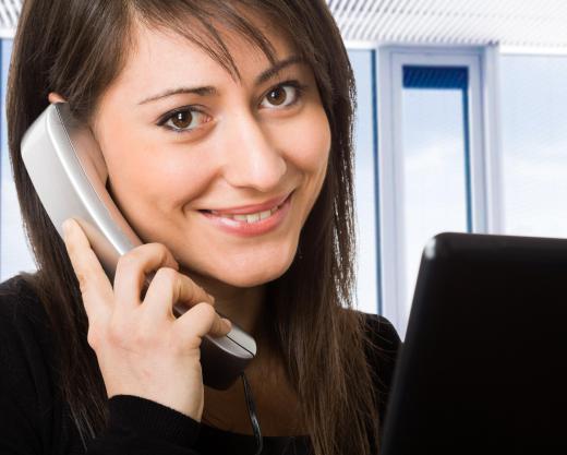 A technical support analyst communicates with customers over the phone in order to assist them with troubleshooting.