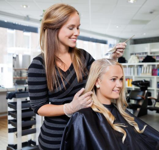 A hair colorist can offer advice on what hair color will look best on a salon customer.