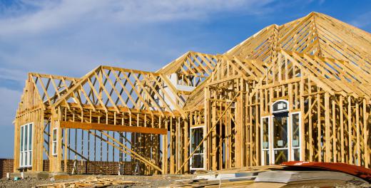 A framer installs the wooden members of a building.