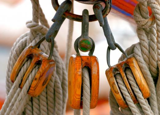 Wooden pulleys hold the rigging on a ship.